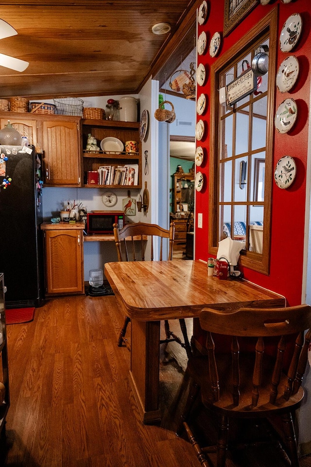 dining area featuring hardwood / wood-style floors and wood ceiling