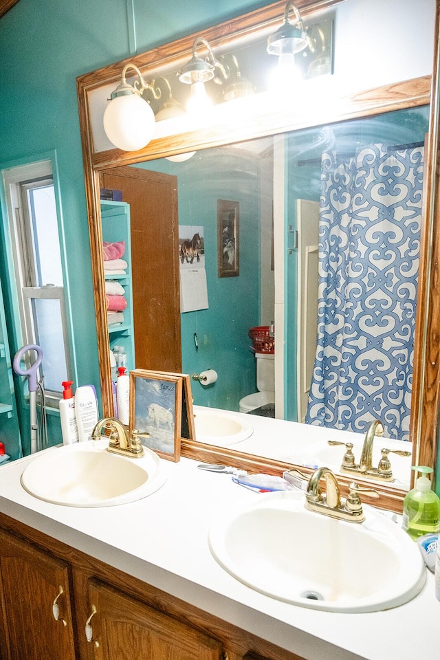 bathroom featuring toilet and vanity