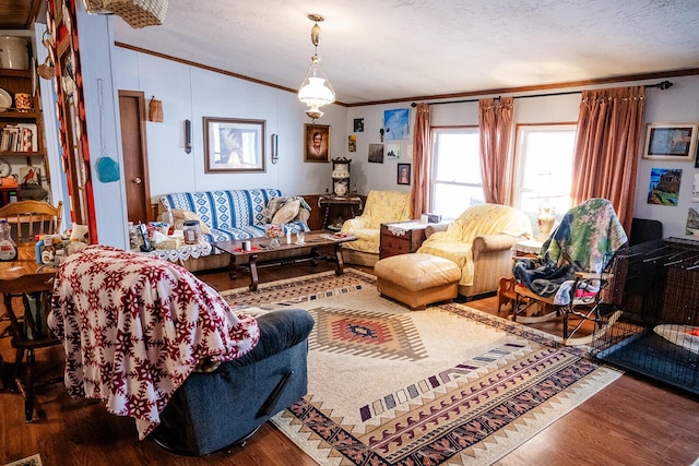 living room featuring a textured ceiling, ornamental molding, hardwood / wood-style flooring, and lofted ceiling