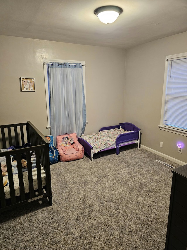 bedroom with carpet flooring and baseboards