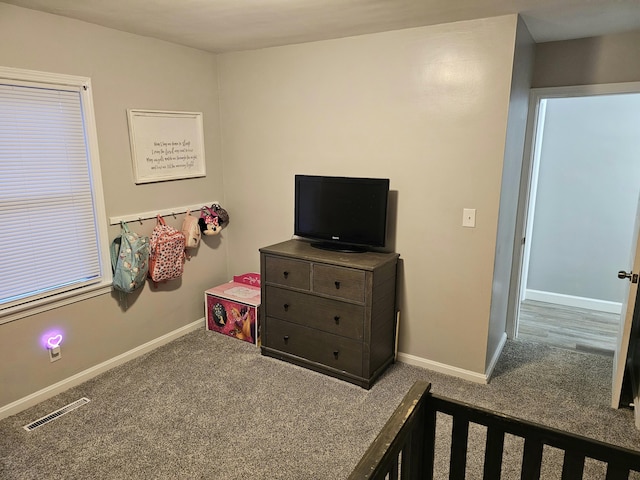 bedroom with baseboards, visible vents, and carpet flooring