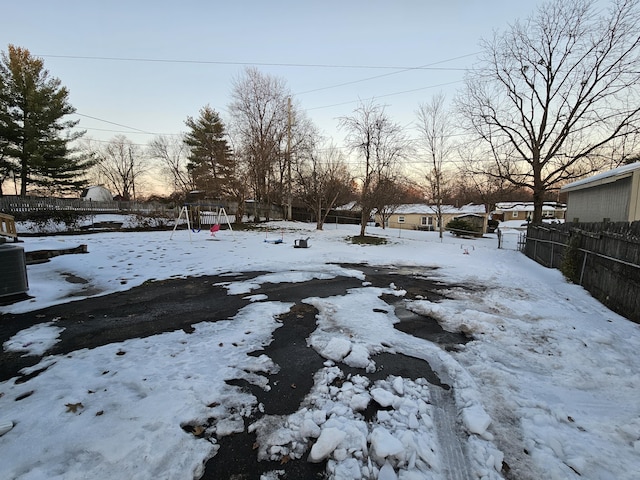 yard covered in snow with central air condition unit