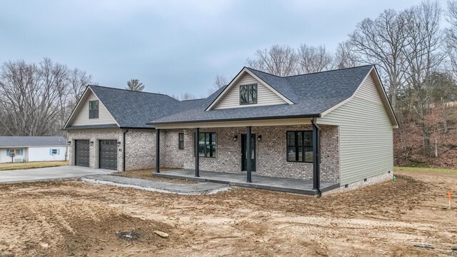 view of front of house featuring a porch and a garage