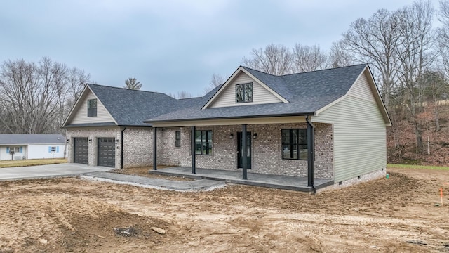 view of front of home featuring a garage and a porch