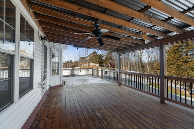 wooden terrace featuring ceiling fan and a playground