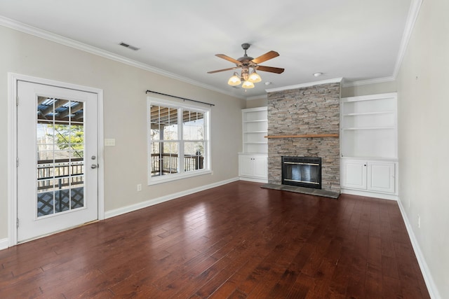 unfurnished living room with crown molding, plenty of natural light, dark hardwood / wood-style floors, and a fireplace