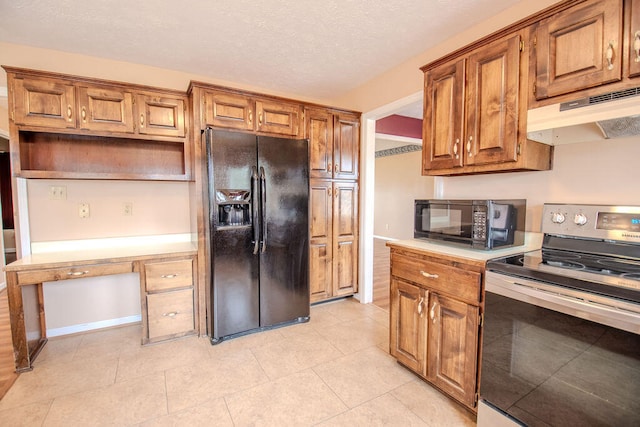 kitchen with built in desk, light tile patterned floors, and black appliances