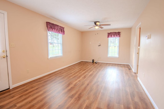 unfurnished room featuring ceiling fan, a healthy amount of sunlight, and wood-type flooring