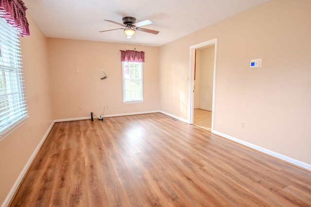 empty room featuring wood-type flooring and ceiling fan