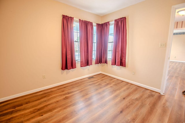 spare room with hardwood / wood-style flooring