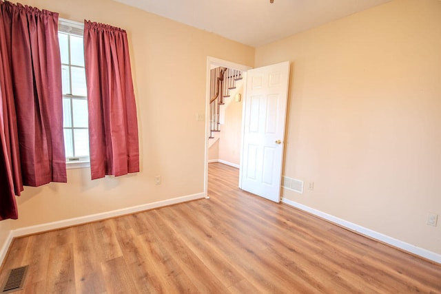 unfurnished room with light hardwood / wood-style floors and a wealth of natural light