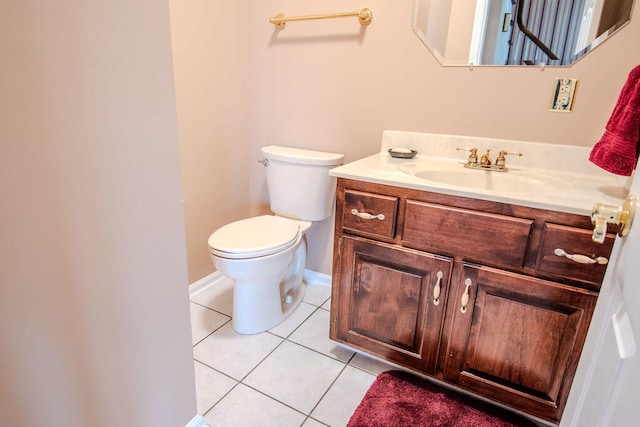 bathroom featuring tile patterned flooring, vanity, and toilet