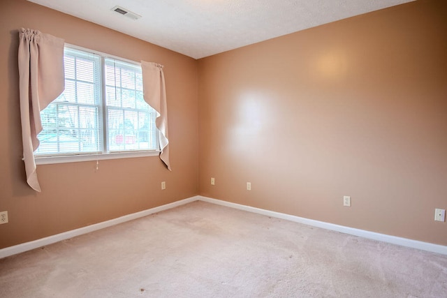 empty room featuring light colored carpet