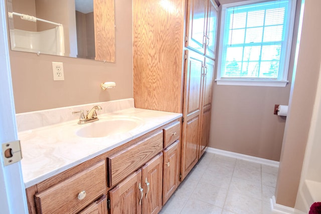 bathroom with walk in shower, vanity, and tile patterned flooring