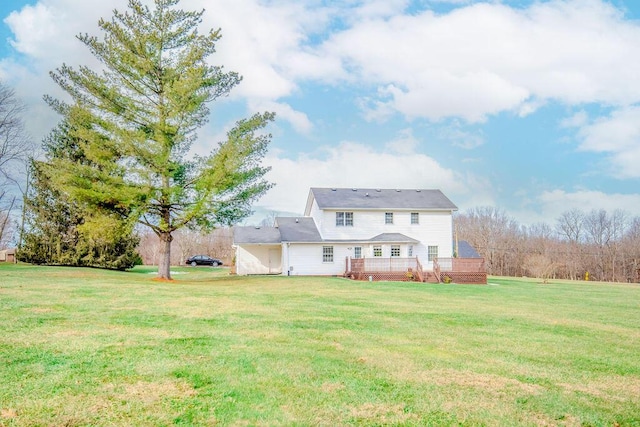 back of house featuring a wooden deck and a yard