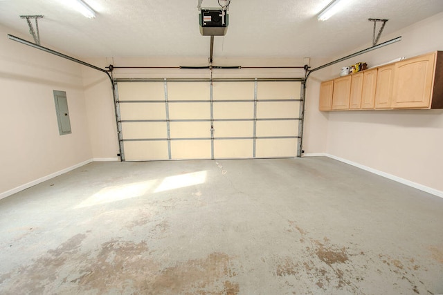 garage with a garage door opener and electric panel