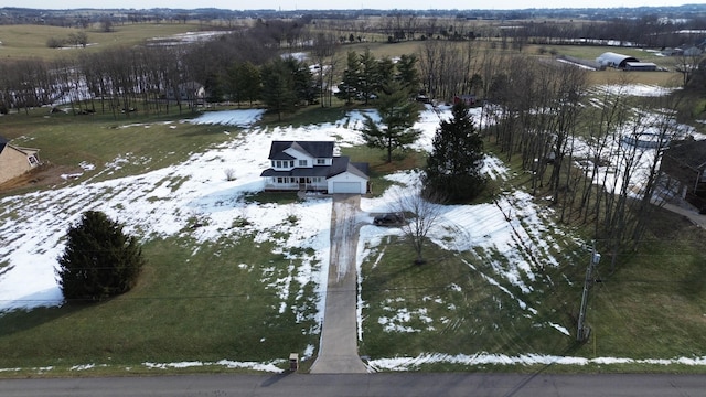 snowy aerial view featuring a rural view