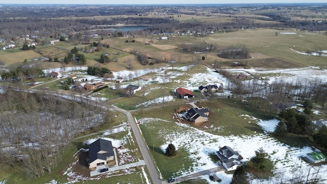 snowy aerial view featuring a rural view