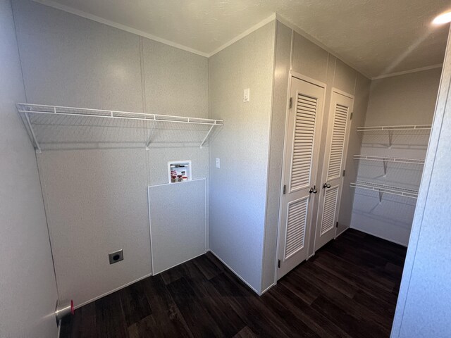 unfurnished room with a textured ceiling, dark wood-type flooring, and crown molding