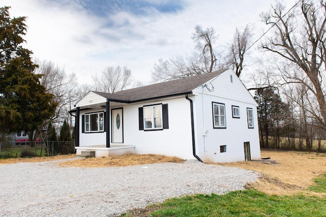 view of front of property featuring fence and a shingled roof