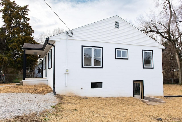 view of side of home featuring concrete block siding