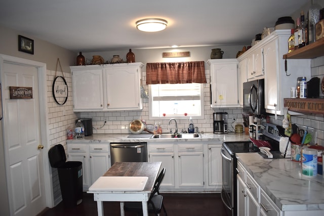 kitchen featuring backsplash, sink, white cabinetry, and appliances with stainless steel finishes