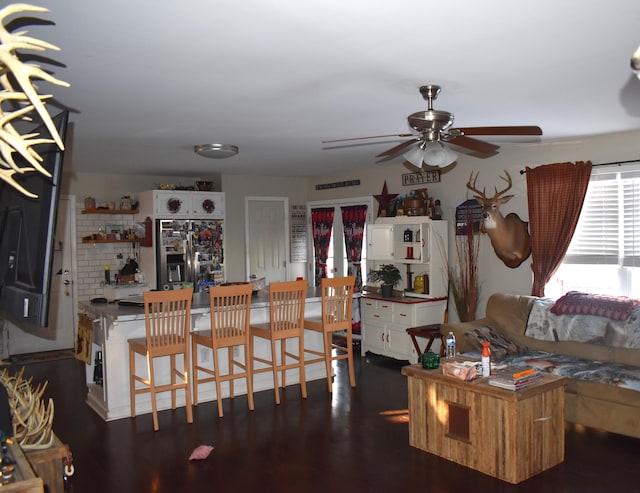 interior space featuring ceiling fan and dark hardwood / wood-style flooring