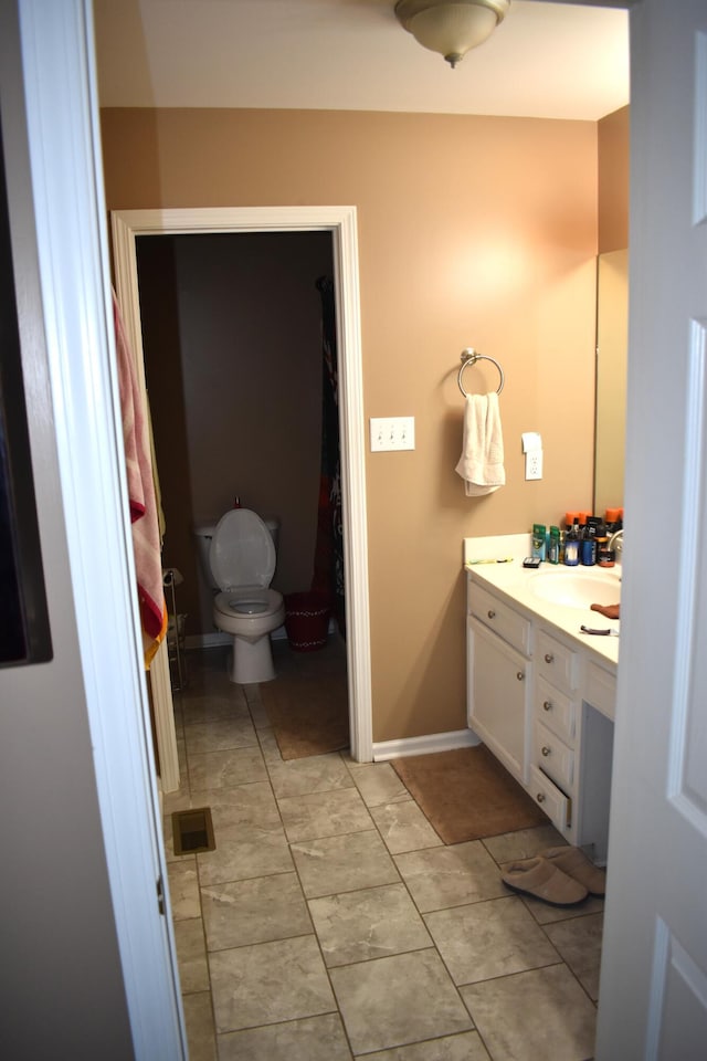 bathroom with toilet and vanity