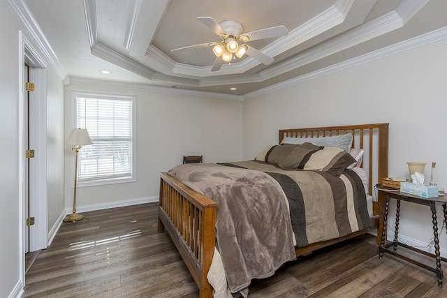 bedroom featuring ceiling fan, dark wood-type flooring, a tray ceiling, and ornamental molding