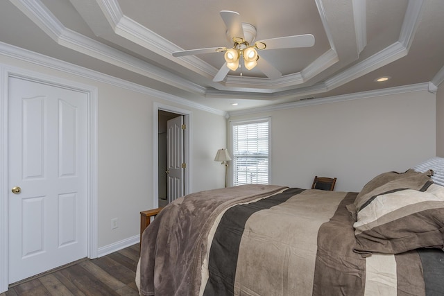 bedroom featuring ceiling fan, dark hardwood / wood-style floors, crown molding, and a tray ceiling