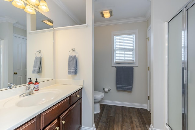 bathroom featuring walk in shower, vanity, toilet, hardwood / wood-style floors, and crown molding