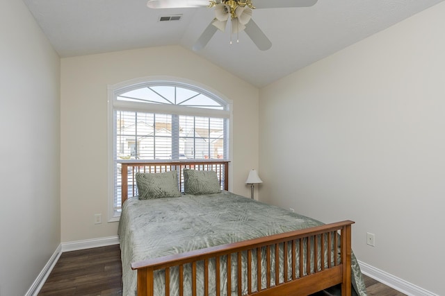 bedroom with ceiling fan, dark hardwood / wood-style floors, and lofted ceiling