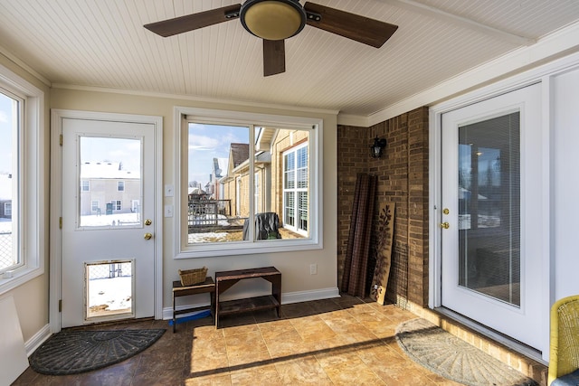 doorway featuring ceiling fan and ornamental molding