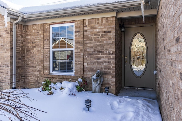 view of snow covered property entrance