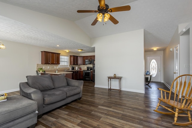 living room featuring vaulted ceiling, ceiling fan, dark hardwood / wood-style flooring, and a textured ceiling