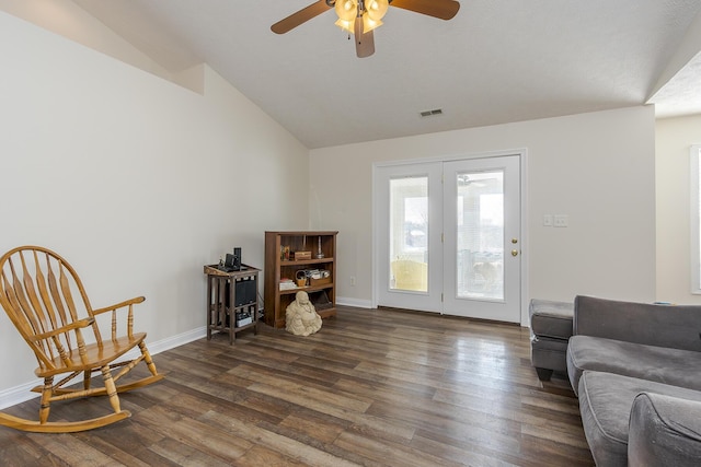 living area with ceiling fan, dark wood-type flooring, and vaulted ceiling