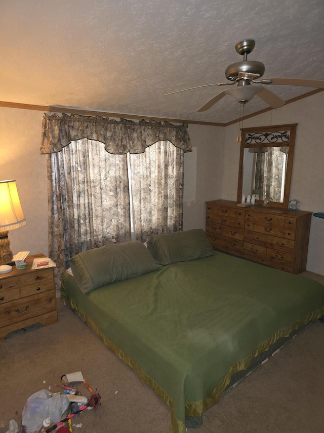 bedroom with ceiling fan, carpet floors, crown molding, and a textured ceiling