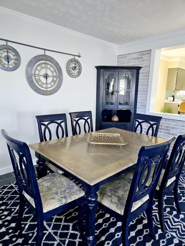 dining space with ornamental molding and a textured ceiling