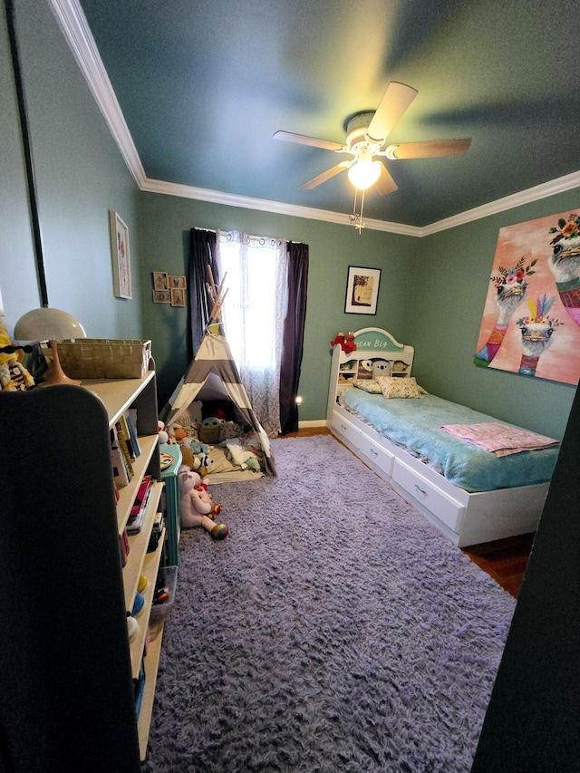 bedroom with ceiling fan, ornamental molding, and carpet floors