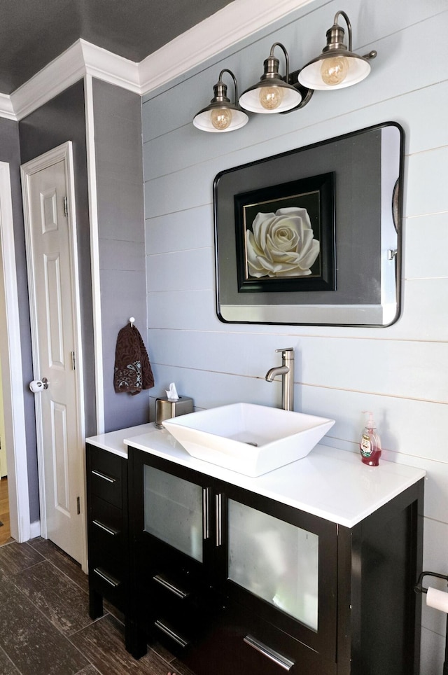 bathroom featuring ornamental molding and vanity