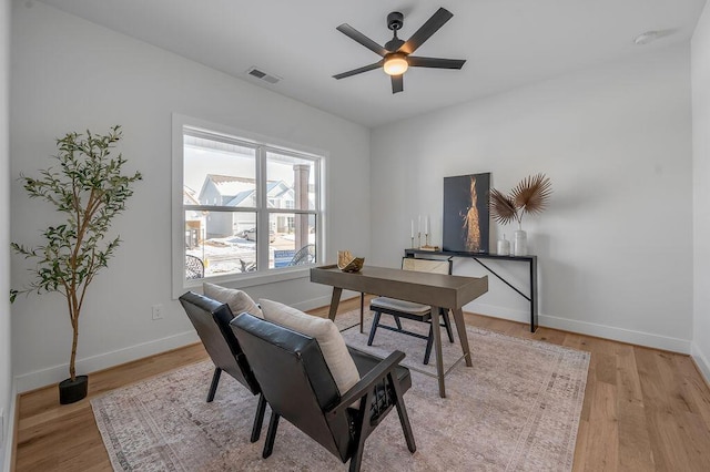 home office featuring ceiling fan and light hardwood / wood-style flooring