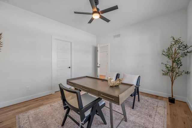 office area with light wood-type flooring and ceiling fan