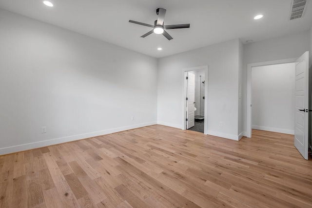 unfurnished bedroom with ceiling fan, ensuite bathroom, and light hardwood / wood-style floors