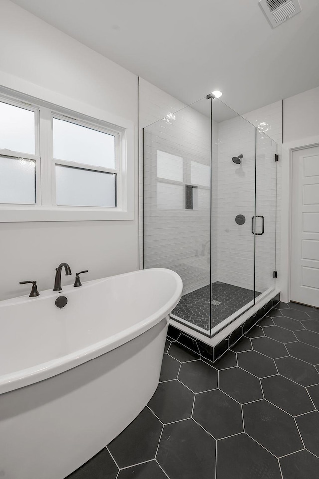 bathroom with tile patterned flooring and plus walk in shower