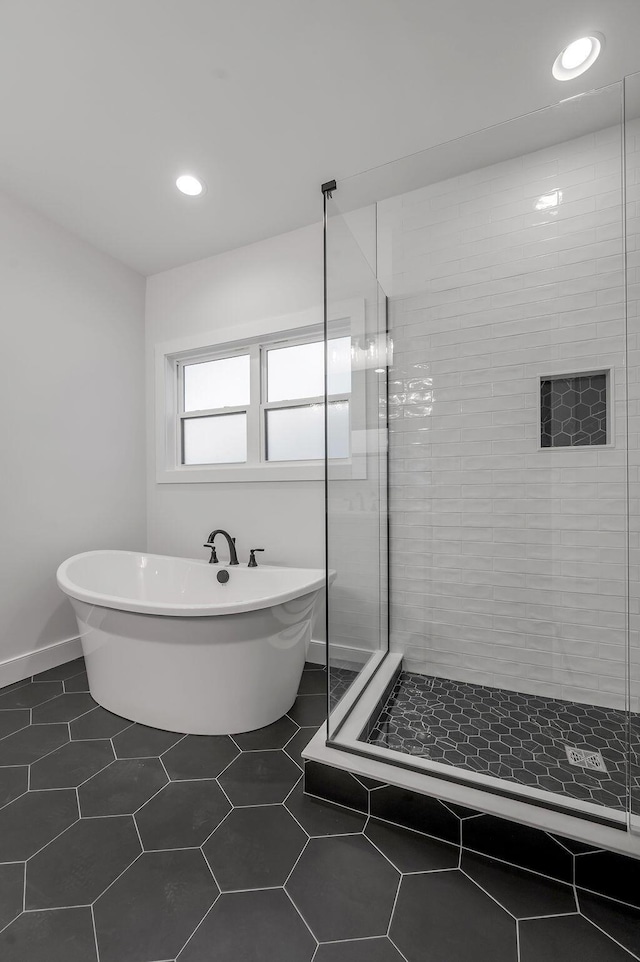 bathroom featuring tile patterned floors and shower with separate bathtub