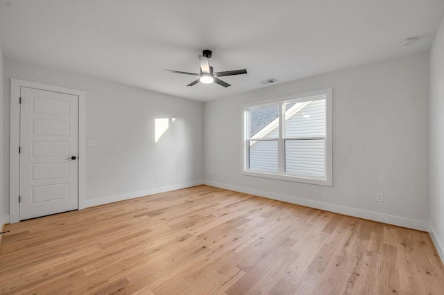 empty room featuring ceiling fan and light hardwood / wood-style floors