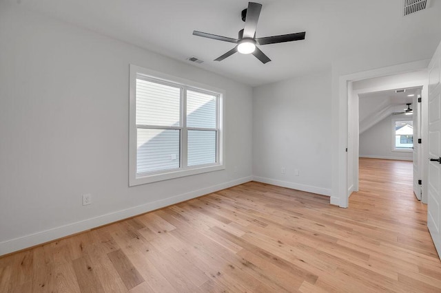 empty room with ceiling fan and light hardwood / wood-style flooring