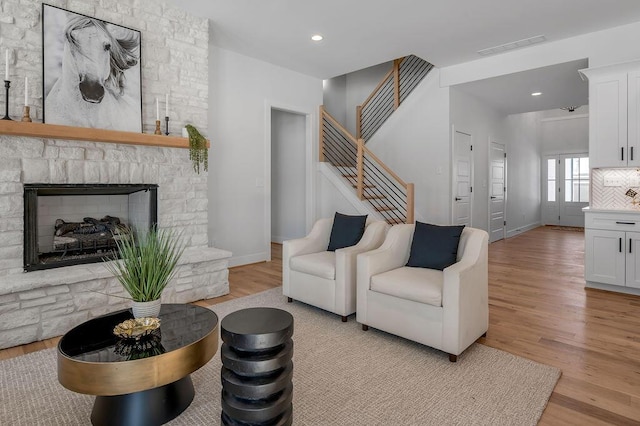 living room with a fireplace and light hardwood / wood-style flooring