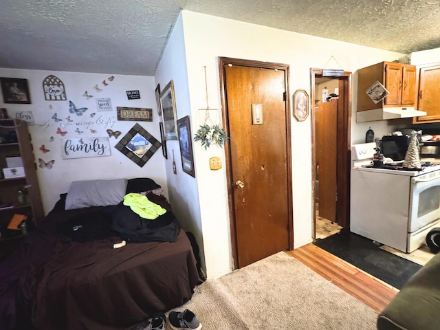 bedroom featuring a textured ceiling and hardwood / wood-style floors