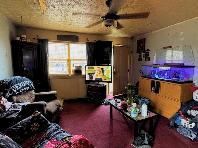 carpeted living room with ceiling fan and a textured ceiling